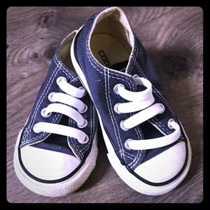 Navy blue low top Chuck Taylors converse
